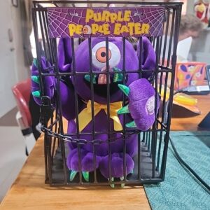 Purple People Eater Plush Toy in Cage
